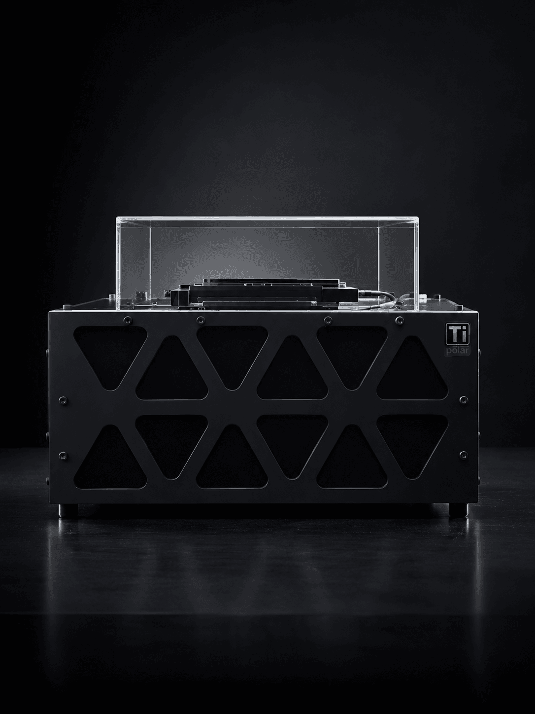 The TiPolar instrument — a black bench-top polarimetric microscope with a clear acrylic lid over its motorized stage.